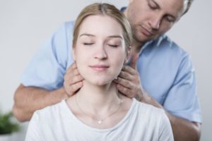 chiropractor adjusting woman's neck