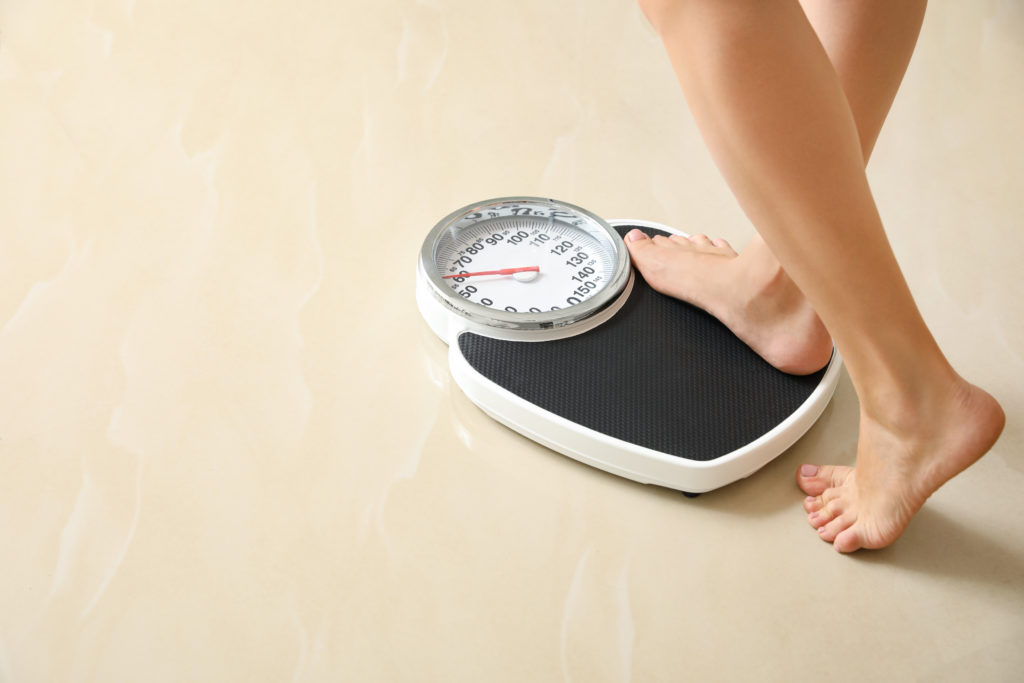woman stepping of floor scale