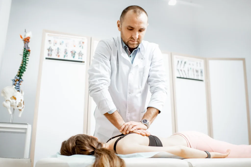 chiropractor adjusting a patient